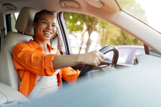 Happy-female-driving-feeling-accomplished