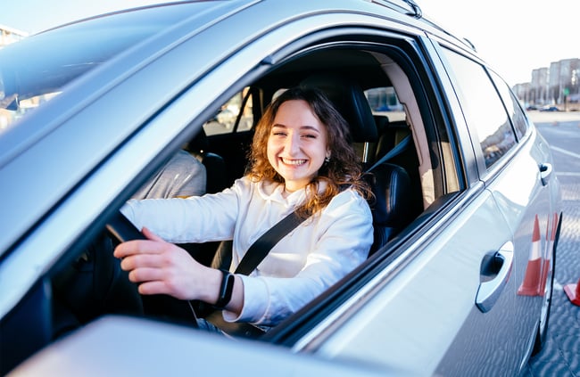 happy-young-woman-taking-defensive-driving-course