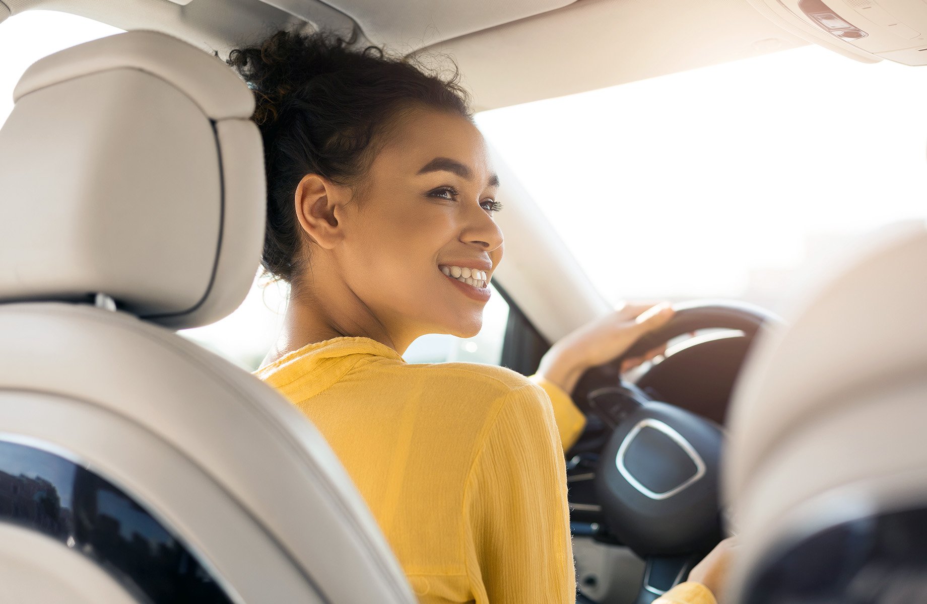 smiling-female-driving-car-with-friend